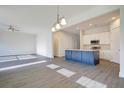 Open living room and kitchen area with hardwood floors and ceiling fan at 2837 Auldreeke Rd, Johns Island, SC 29455