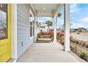 Porch with wooden swing, overlooking the neighborhood at 327 Great Lawn Dr, Summerville, SC 29486