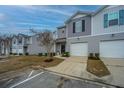 Townhomes with gray siding, white garage doors, and landscaping at 523 Truman Dr, Goose Creek, SC 29445