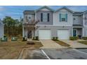 Two-story townhome with attached garage and manicured landscaping at 523 Truman Dr, Goose Creek, SC 29445