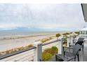 Beachfront view from deck with lounge chairs and ocean access at 58 Grand Pavilion Blvd, Isle of Palms, SC 29451