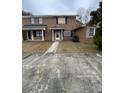 Brick townhouse with damaged windows and a small front yard at 7734 Suzanne Dr, North Charleston, SC 29418