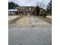 Two-story brick townhouse needing repairs, in a residential neighborhood at 7734 Suzanne Dr, North Charleston, SC 29418