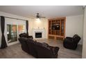 Living room with fireplace, built-in shelving, and leather furniture at 8245 Governors Walk, North Charleston, SC 29418