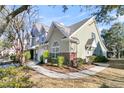Tan and green two story townhome with a nicely landscaped yard and walkway at 8646 Grassy Oak Trl, North Charleston, SC 29420