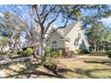 Attractive two-story townhome with green siding, brick accents, and mature landscaping at 8646 Grassy Oak Trl, North Charleston, SC 29420