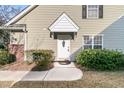White front door with a charming wreath, and well maintained landscaping at 8646 Grassy Oak Trl, North Charleston, SC 29420