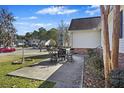 Concrete patio with metal table and chairs, offering an outdoor dining space at 9609 Crosscut Dr, Ladson, SC 29456