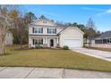 Two-story house with beige siding, a white garage door, and landscaping at 126 Veranda Dr, Summerville, SC 29485