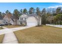 House exterior showcasing a two-car garage and well-manicured lawn at 126 Veranda Dr, Summerville, SC 29485