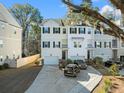Three-story townhouses with attached garages and landscaping at 137 Claret Cup Way, Charleston, SC 29414