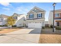 Two-story house with gray siding, white garage doors, and a landscaped yard at 241 Swamp Creek Ln, Moncks Corner, SC 29461