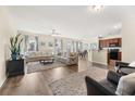 Spacious living room with hardwood floors, sectional sofa, and large windows at 241 Swamp Creek Ln, Moncks Corner, SC 29461