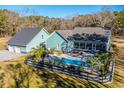 An aerial view of a home with a pool and detached garage at 490 Cummings Chapel Rd, Ridgeville, SC 29472