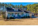 A light blue house with a wraparound porch and manicured lawn at 490 Cummings Chapel Rd, Ridgeville, SC 29472