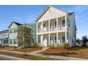 Two-story white house with front porch, landscaping, and sidewalk at 507 N Commodore Way, Summerville, SC 29483