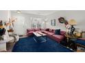 Spacious living room with mauve sectional sofa, blue rug, and coffee table at 5222 Chicory Ln, North Charleston, SC 29420