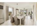 Bright dining area with light wood table and access to the living room at 723 Blue Iris Way, Summerville, SC 29486