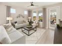 Cozy living room with comfy seating and access to backyard patio at 723 Blue Iris Way, Summerville, SC 29486