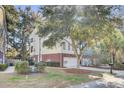 Side view of townhome showcasing landscaping and garage at 9185 Parlor Dr, Ladson, SC 29456