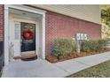 Black front door with wreath, brick facade, and sidelights at 9185 Parlor Dr, Ladson, SC 29456