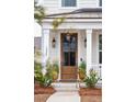 Stylish front door entrance with potted plants at 1245 Crooked Oak Rd, Charleston, SC 29492