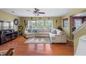 Spacious living room with hardwood floors, large sectional sofa, and fireplace at 130 Decatur Dr, Summerville, SC 29486