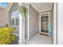 Inviting front porch with black door, welcome mat, and hanging planter at 133 Summit View Dr, Summerville, SC 29486