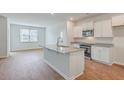 Kitchen boasts white cabinets, granite countertops, and stainless steel appliances at 133 Summit View Dr, Summerville, SC 29486