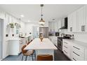 Modern white kitchen with stainless steel appliances and large island at 1446 Fort Johnson Rd, Charleston, SC 29412