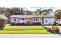 Ranch style home with a yellow door and well-manicured lawn at 1569 Westwood Dr, Charleston, SC 29412