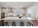 Modern kitchen with white cabinets, quartz countertops, and an island with seating at 2251 Spring Hope Dr, Mount Pleasant, SC 29466