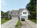 Two-story home with gray siding, brick accents, and a two-car garage at 2670 Lamina Ct, Mount Pleasant, SC 29466