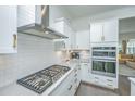Modern kitchen with white cabinets, stainless steel appliances, and gas cooktop at 2910 Clearwater Dr, Mount Pleasant, SC 29466