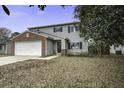 Two-story house with brick and siding, attached garage, and front yard at 305 Catawba Dr, Summerville, SC 29483