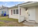 Front view of a charming white brick home with a white door and small porch at 3104 Azalea Dr # B, North Charleston, SC 29405