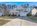 Two-story house with gray siding, stone accents, and a two-car garage at 339 Spectrum Rd, Summerville, SC 29486