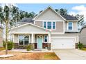 Two-story house with gray siding, stone accents, and a light blue front door at 339 Spectrum Rd, Summerville, SC 29486