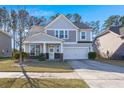Two-story house with gray siding, stone accents, and a two-car garage at 339 Spectrum Rd, Summerville, SC 29486
