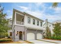 Two-story home with white siding, gray accents, and a three-car garage at 341 Bridgetown Pass, Mount Pleasant, SC 29464