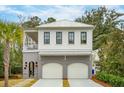 Two-story home with white siding, gray accents, and a three-car garage at 341 Bridgetown Pass, Mount Pleasant, SC 29464