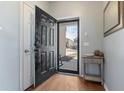 Front entry with black door, wood floors, and coat closet at 356 Peters Creek Dr, Summerville, SC 29486