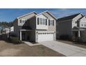 Two-story house with gray siding, white garage door, and driveway at 356 Peters Creek Dr, Summerville, SC 29486