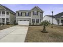 Two-story house with gray siding, black shutters, and a two-car garage at 484 Whispering Breeze Ln, Summerville, SC 29486