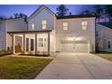 Two-story white house with gray roof, front porch, and attached garage at night at 530 Richfield Way, Summerville, SC 29486