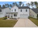 Two-story white house with gray roof, front porch, and attached garage at 530 Richfield Way, Summerville, SC 29486