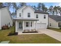 Two-story white house with gray roof, front porch, and attached garage at 530 Richfield Way, Summerville, SC 29486
