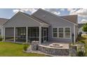 Screened porch and fire pit enhance the backyard at 546 Four Seasons Blvd, Summerville, SC 29486