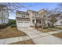 Two-story house with gray siding, white double garage doors, and landscaping at 705 Quintan St, Summerville, SC 29486