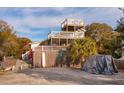 Beach house exterior with multiple decks and surfboard storage at 904 E Arctic Ave, Folly Beach, SC 29439